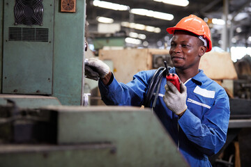 technician or foreman fixing machine and talking on walkie talkie in the factory