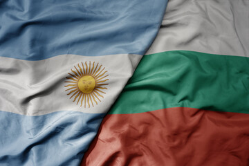 big waving national colorful flag of bulgaria and national flag of argentina .