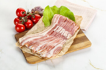 Sliced pork bacon oved board