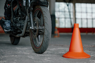 Closeup view on wheel of training motorcycle at driving school motordrome