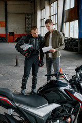 Fototapeta na wymiar Student motorcyclist and instructor looking at test exam list