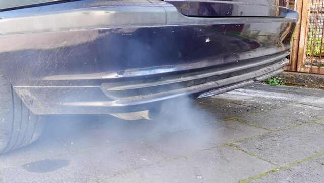 car diesel engine ignition. monoxide air pollution caused by tailpipe with blue and black smoke. climate change.