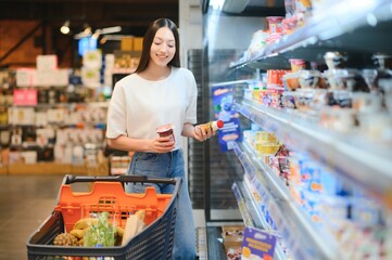 Groceries Shopping. Portrait Of Smiling Happy Woman Leaning On Trolley Cart In Supermarket