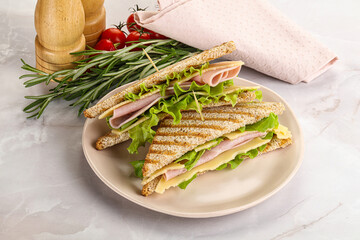 Homemade club sandwich with ham and cheese