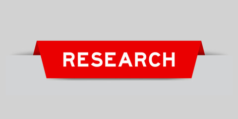 Red color inserted label with word research on gray background