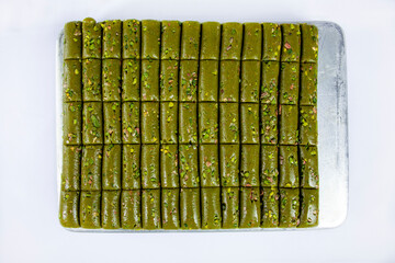 Top view of pistachio rolls on tray isolated on white background.