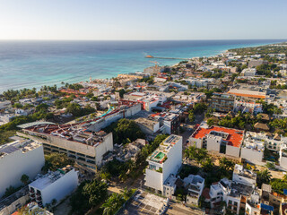 Fototapeta na wymiar Aerial drone view of blue Caribbean Sea and downtown area in Playa del Carmen on a cloudless blue sky morning 