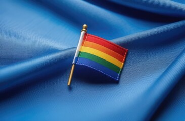 Rainbow LGBTQ flag on blue fabric background