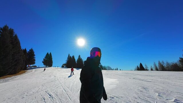 SLOW MOTION Snowboarder on a ski slope on a sunny day