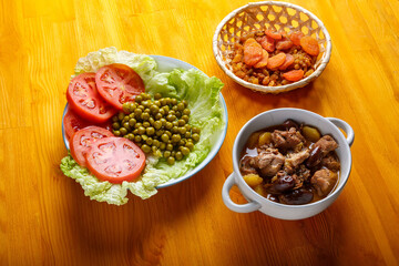 Lamb stewed with potatoes in spices and sauce next to dried fruits and vegetables iftar