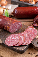 Smoked sausage on a wooden rustic board. Rustic table