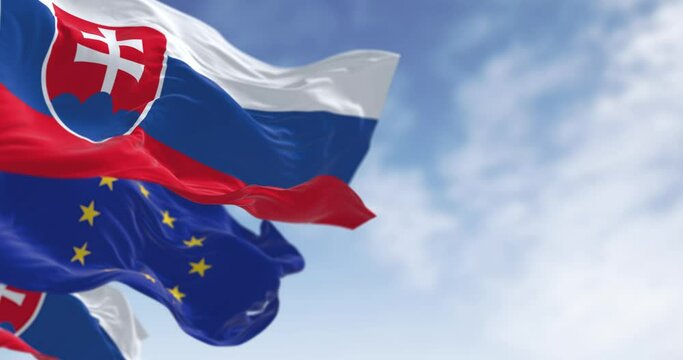 Close-up of Slovakia and the European Union flags waving on a clear day