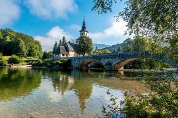 Church of St John the Baptist with bridge over Sava River in Bohinj Lake, Slovenia. 