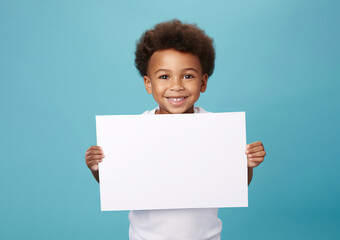 boy hold a blank placard sign poster paper in his hands. empty space for editing on pastel blue background