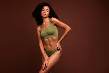  No filter photo of gentle perfect girl posing in new collection activewear promoting top and panties isolated on brown color background © deagreez