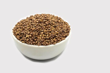 Flaxseed or Linseed in a White Bowl Isolated on White Background with Copy Space, Also Known as Common Flax or Linum Usitatissimum