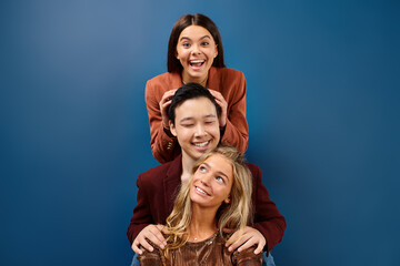 merry diverse adolescents in elegant outfits smiling at camera while posing together, friendship day