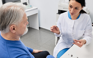 Fototapeta premium ITC hearing aids. In-the-canal hearing aids are recommended by audioprosthetist to elderly patient because it is best hearing solutions