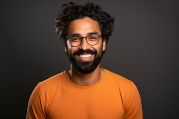 Fototapeta premium Portrait of a successful smiling bearded man in glasses on an dark background