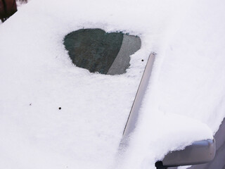 Photo of a fragment of a car covered with snow.