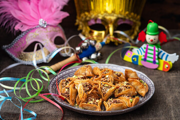 Purim celebration concept (jewish carnival holiday).Hamantaschen cookies and masks	