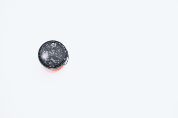 Hot coffee in a red paper cup on the snow outside during a snowfall, top view