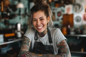 Fotobehang Cheerful young tattoo artist with tattooed hands posing in tattoo studio. © MNStudio
