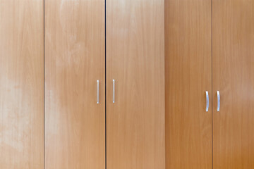 Wooden cabinet doors. Texture of an old brown cabinet with doors