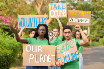 Group of activists protesting with placards asking to take care of the planet