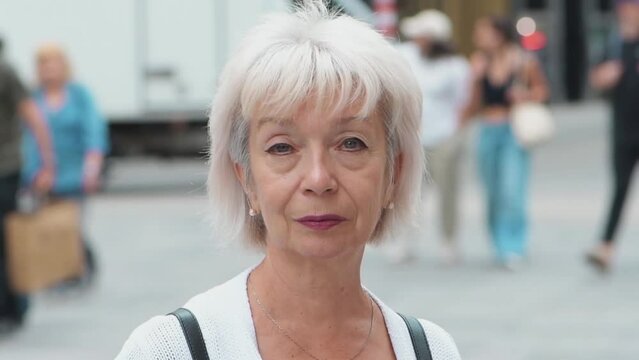 Elegant elderly woman 65-70 years old on the blurr