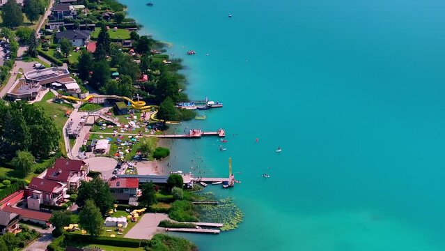 drone view of the bay of faak's lake in Austria with people enjoying the beach