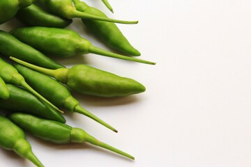 Green bird's eye chili, fresh chili peppers. close up photo on white background copy space 