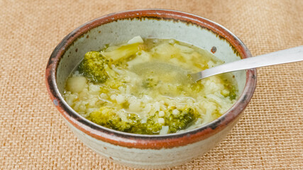 Bowl of cauliflower broccoli soup close-up on a table