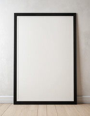 blank black poster frame on light wooden floor, empty picture frame mockup, blank vertical frame