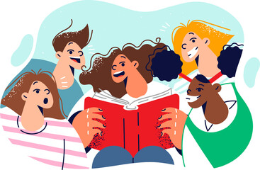 Happy children read book standing around classmate with encyclopedia and are surprised open mouths