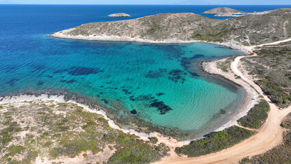 Aerial drone photo of beautiful crystal clear turquoise beach and cave formations visited by yachts...