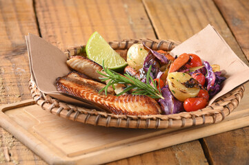 fried fish seasoned with herbs herb sauce vegetables tomato lemon tasty and healthy food