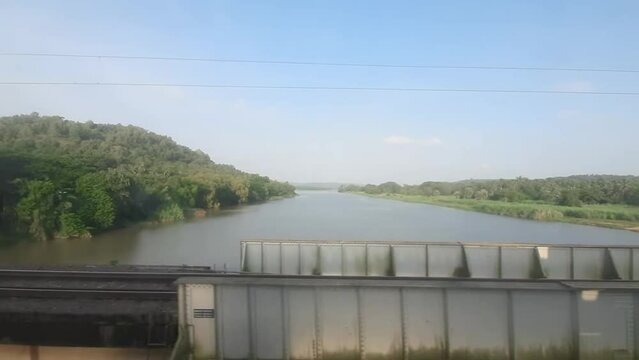 view of the river while traveling by train