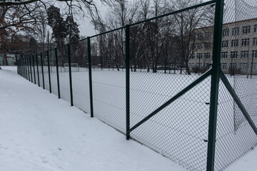 School soccer field covered with snow