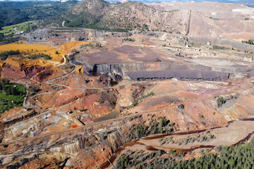 Aerial drone view of old copper and gold mining exploitation in Minas de Riotinto with beautiful brown, ocher, yellow and red colors in Huelva mountains, Andalusia, Spain