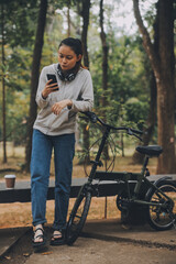 Happy Asian young woman walk and ride bicycle in park, street city her smiling using bike of transportation, ECO friendly, People lifestyle concept.