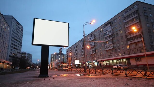 Empty billboard at evening street during winter in city
