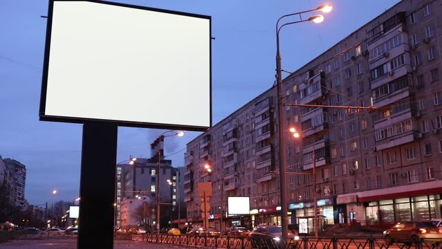 Empty billboard at night street in city, slow motion