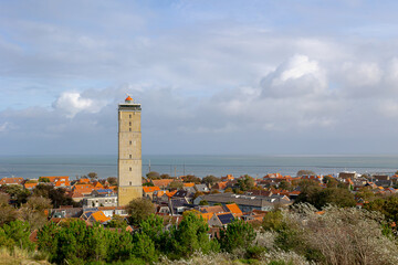 Fototapeta na wymiar A small town in West-Terschelling with blue sky, Brandaris lighthouse (Vuurtoren Brandaris) on the Dutch Wadden Sea, A municipality and an island in the northern, Terschelling, Friesland, Netherlands.