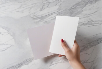Vertical Empty Greeting Card Mockup with Hands on Marble Background
