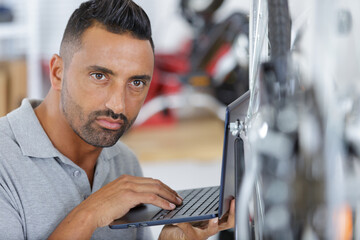 man checking fitness test on exercise bike