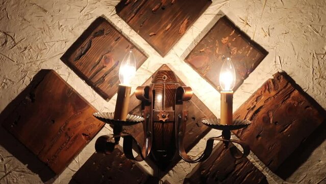Wall bracket made of wood and metal with two lamps turns off and turns on