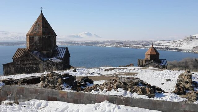 Two buildings of monastery Sevanavank on Sevan lake in winter sunny day