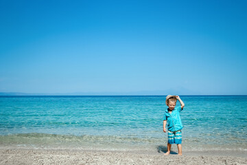 Fototapeta premium A happy child by the sea in nature weekend travel