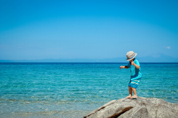 A happy child by the sea in nature weekend travel